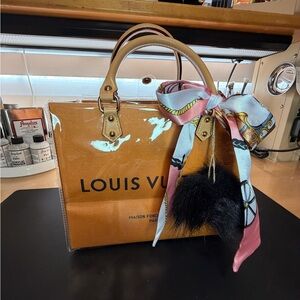 Louis Vuitton Brown and Tan poly shopping bag.